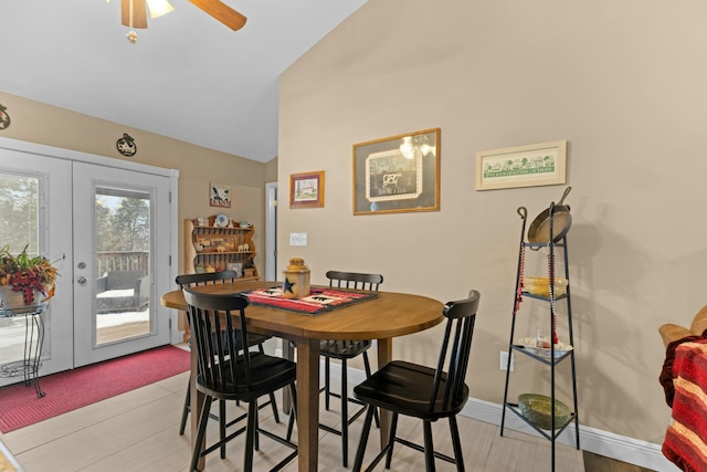 dining area with lofted ceiling, french doors, ceiling fan, and light hardwood / wood-style floors