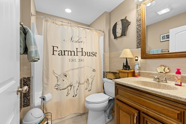 bathroom featuring toilet, a shower with shower curtain, vanity, and tile patterned floors