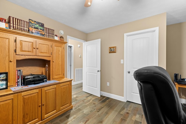 office featuring hardwood / wood-style flooring and ceiling fan