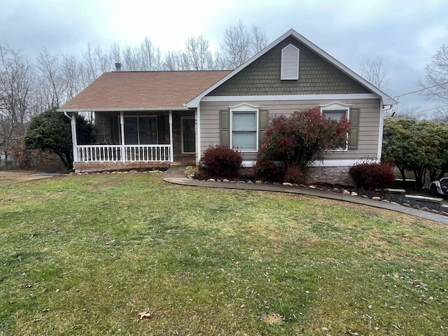 view of front of home featuring covered porch and a front yard