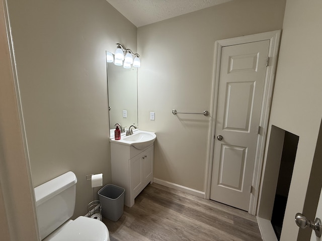 968 Cedar Trace Ln, Morristown, TN 37814 - half bath with vanity, wood finished floors, toilet, a textured ceiling, and baseboards