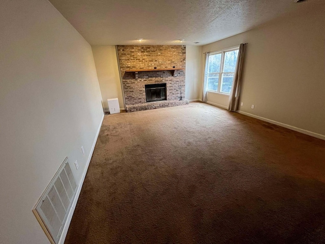 unfurnished living room with carpet floors, a textured ceiling, and a fireplace