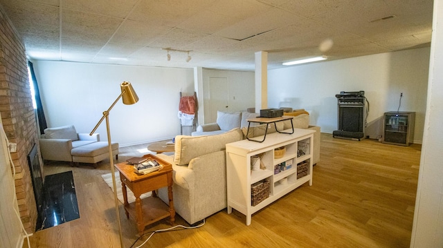 living area featuring a paneled ceiling, visible vents, wine cooler, and wood finished floors