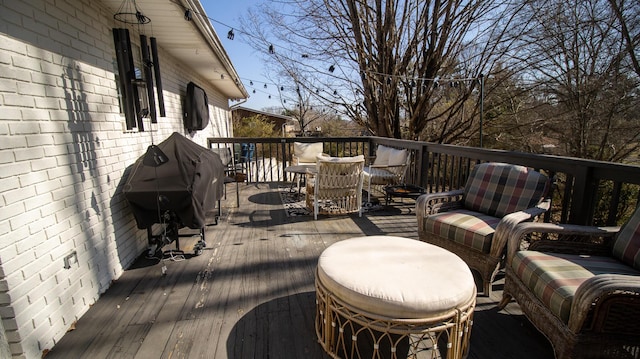 wooden deck featuring grilling area and outdoor lounge area