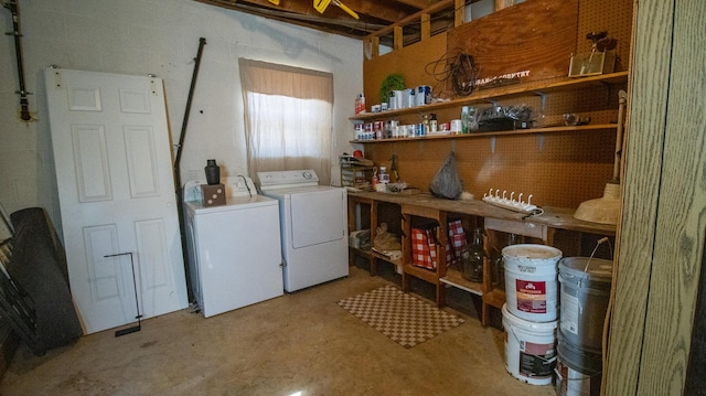 washroom featuring washing machine and clothes dryer, laundry area, and concrete block wall