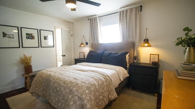 bedroom featuring ceiling fan, baseboards, and wood finished floors