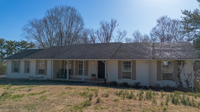 ranch-style house featuring brick siding and a porch