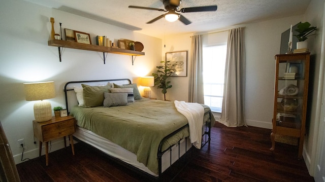 bedroom featuring a ceiling fan, baseboards, wood-type flooring, and a textured ceiling