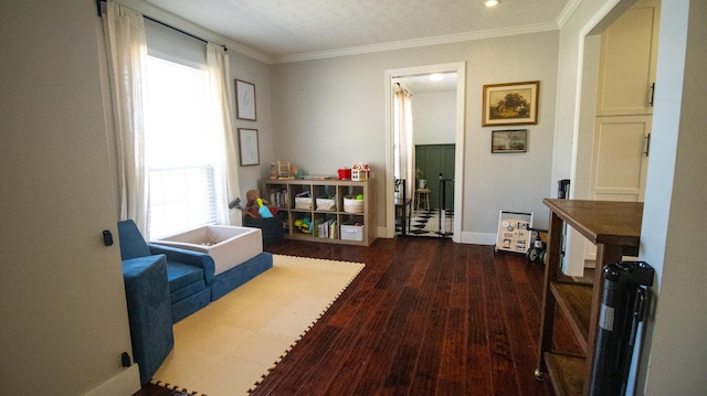 interior space with ornamental molding, baseboards, and wood finished floors