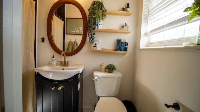 bathroom with toilet and vanity