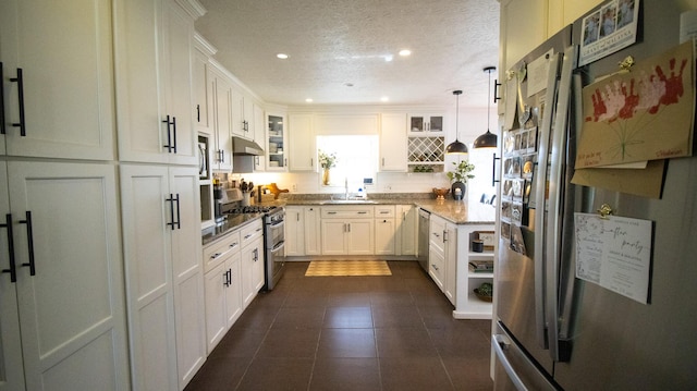 kitchen with a textured ceiling, recessed lighting, stainless steel appliances, white cabinets, and glass insert cabinets