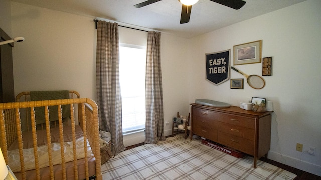 bedroom with a ceiling fan and baseboards