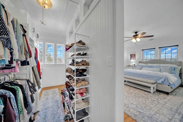 spacious closet with a ceiling fan and wood finished floors