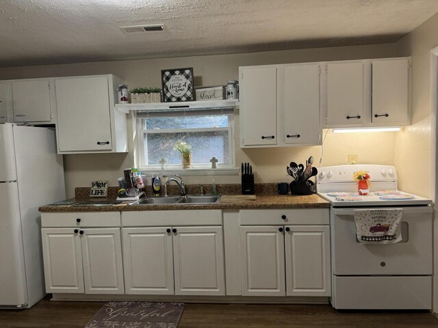 kitchen with a textured ceiling, white appliances, sink, white cabinets, and dark hardwood / wood-style floors