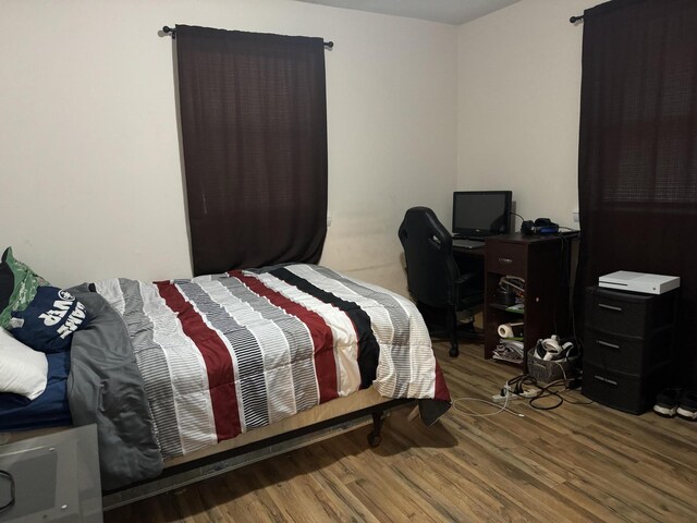 bedroom with hardwood / wood-style flooring