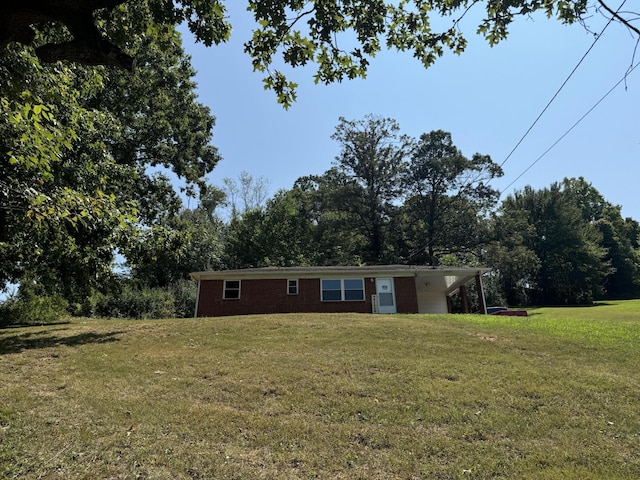 view of front facade with a carport and a front lawn