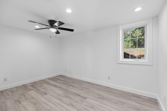 spare room with light hardwood / wood-style flooring and ceiling fan