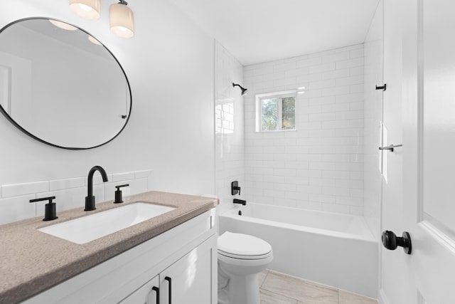 full bathroom with vanity, toilet, and tiled shower / bath