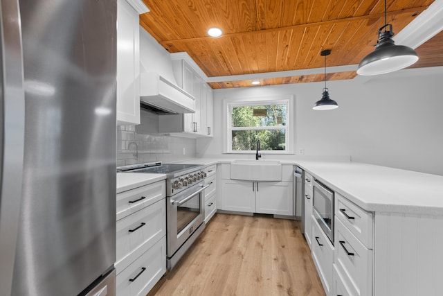 kitchen with pendant lighting, white cabinetry, backsplash, and appliances with stainless steel finishes