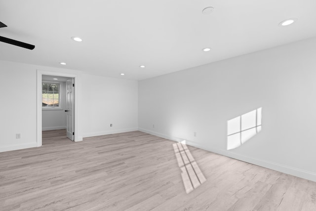 empty room featuring ceiling fan and light hardwood / wood-style flooring