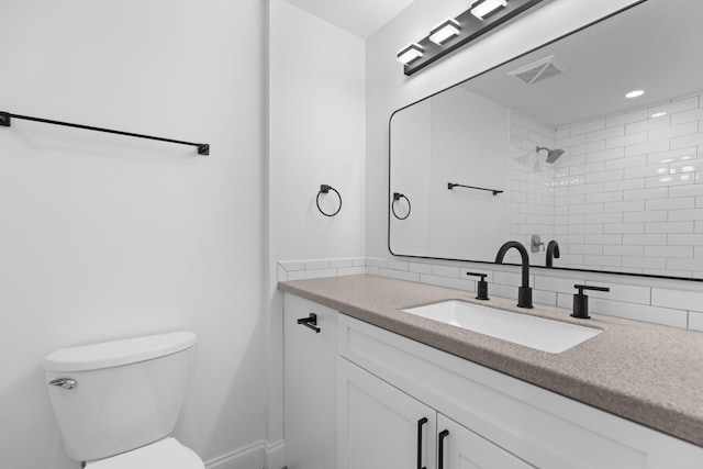 bathroom featuring decorative backsplash, a shower, vanity, and toilet