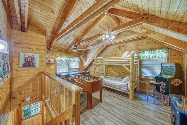 bedroom featuring wooden ceiling, wooden walls, multiple windows, and wood finished floors