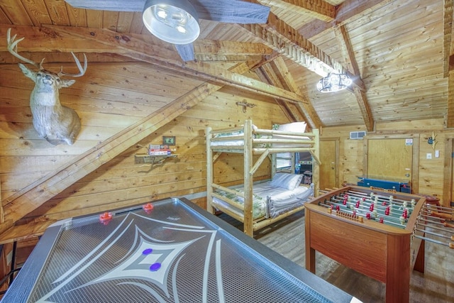 bedroom with wood walls, wood ceiling, and wood finished floors