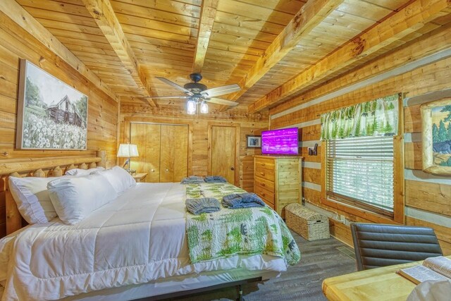 bedroom with wooden ceiling, wood walls, wood finished floors, and beam ceiling