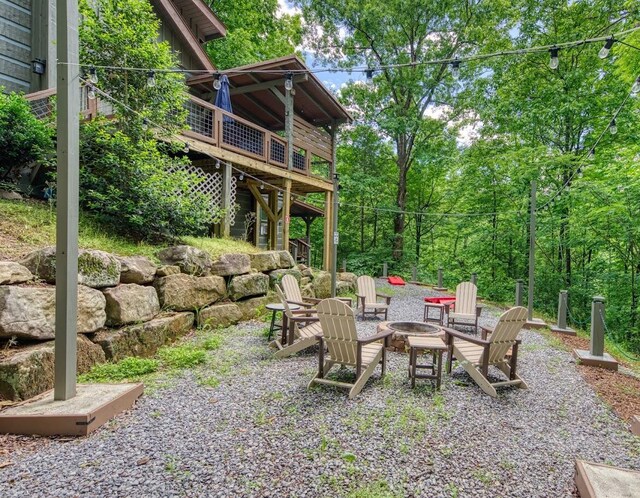 view of patio featuring a fire pit and a wooden deck