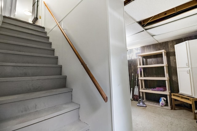 stairway featuring a paneled ceiling