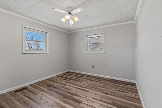 unfurnished room with hardwood / wood-style flooring, ceiling fan, and ornamental molding