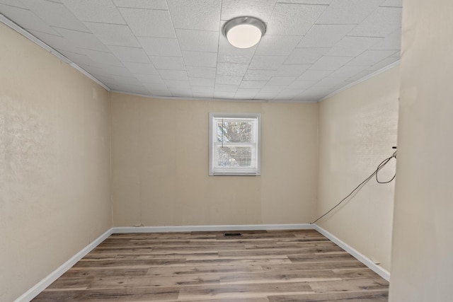 unfurnished room featuring crown molding and light hardwood / wood-style flooring