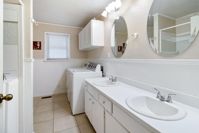 bathroom with washer and clothes dryer, tile patterned flooring, crown molding, and vanity