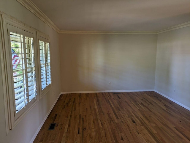 spare room featuring dark hardwood / wood-style floors and ornamental molding