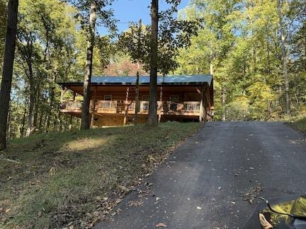 log-style house featuring a deck