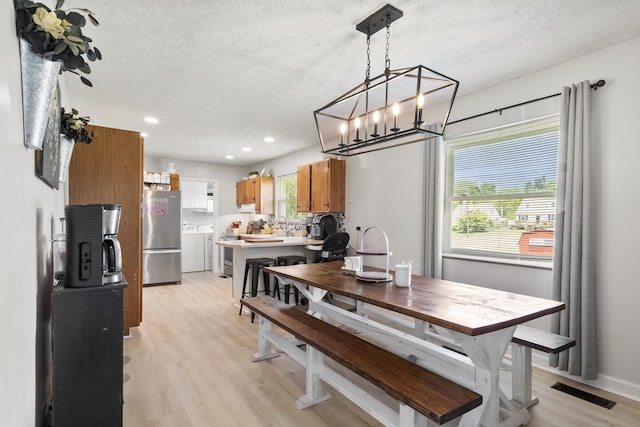 2121 Fir St, Morristown, TN 37813 - dining space with a textured ceiling, light wood-style floors, healthy amount of natural light, recessed lighting, and separate washer and dryer