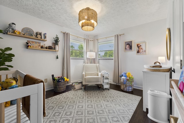 2121 Fir St, Morristown, TN 37813 - bedroom featuring a textured ceiling, wood finished floors, baseboards, and a chandelier