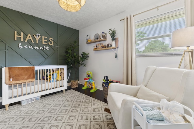 2121 Fir St, Morristown, TN 37813 - bedroom featuring a nursery area, baseboards, and a textured ceiling