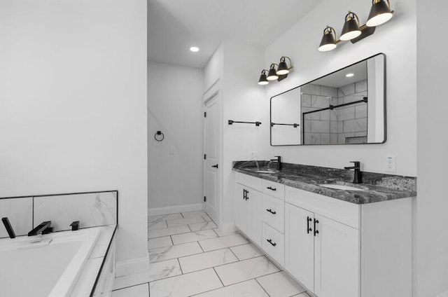 bathroom with vanity and a bath