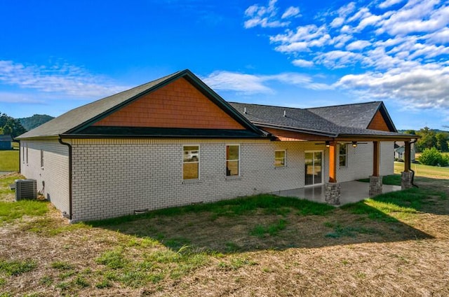 back of house with a lawn, ceiling fan, a patio, and central AC unit