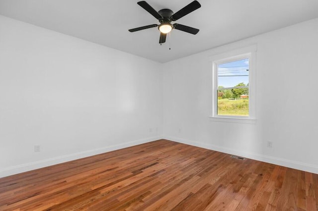 empty room featuring hardwood / wood-style floors and ceiling fan