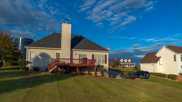 rear view of house featuring a yard and a wooden deck