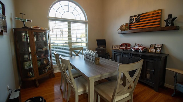 dining space with wood-type flooring