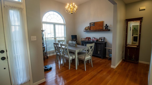 dining space featuring a notable chandelier and dark hardwood / wood-style floors