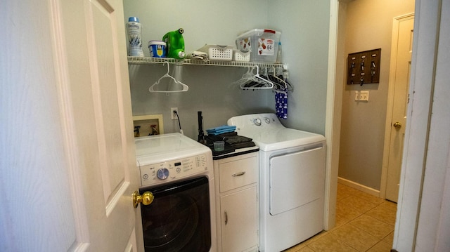 washroom featuring light tile patterned flooring and washer and dryer