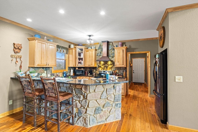 2760 Forest Ridge Rd, Dandridge, TN 37725 - kitchen featuring wall chimney range hood, freestanding refrigerator, tasteful backsplash, a peninsula, and ornamental molding