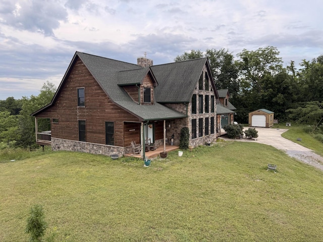 2760 Forest Ridge Rd, Dandridge, TN 37725 - view of front facade with driveway, a shingled roof, a front lawn, and an outdoor structure