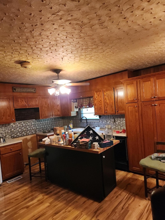 204 Clearview Dr, Bean Station, TN 37708 - kitchen with brown cabinetry, a ceiling fan, light wood-style floors, decorative backsplash, and a sink