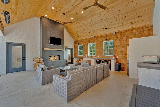 1936 Turners Landing Rd, Russellville, TN 37860 - living room featuring brick wall, wood ceiling, an outdoor brick fireplace, ceiling fan, and high vaulted ceiling