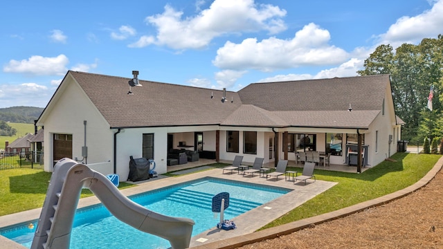 back of house featuring a patio, an outdoor hangout area, and a lawn